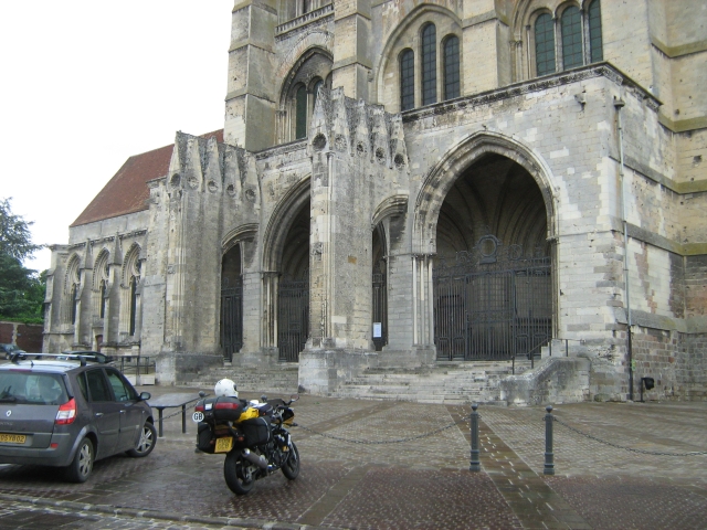 my bike outside a large imposing church in france